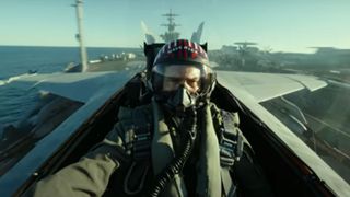 Tom Cruise in a plane's cockpit taking off from a carrier ship
