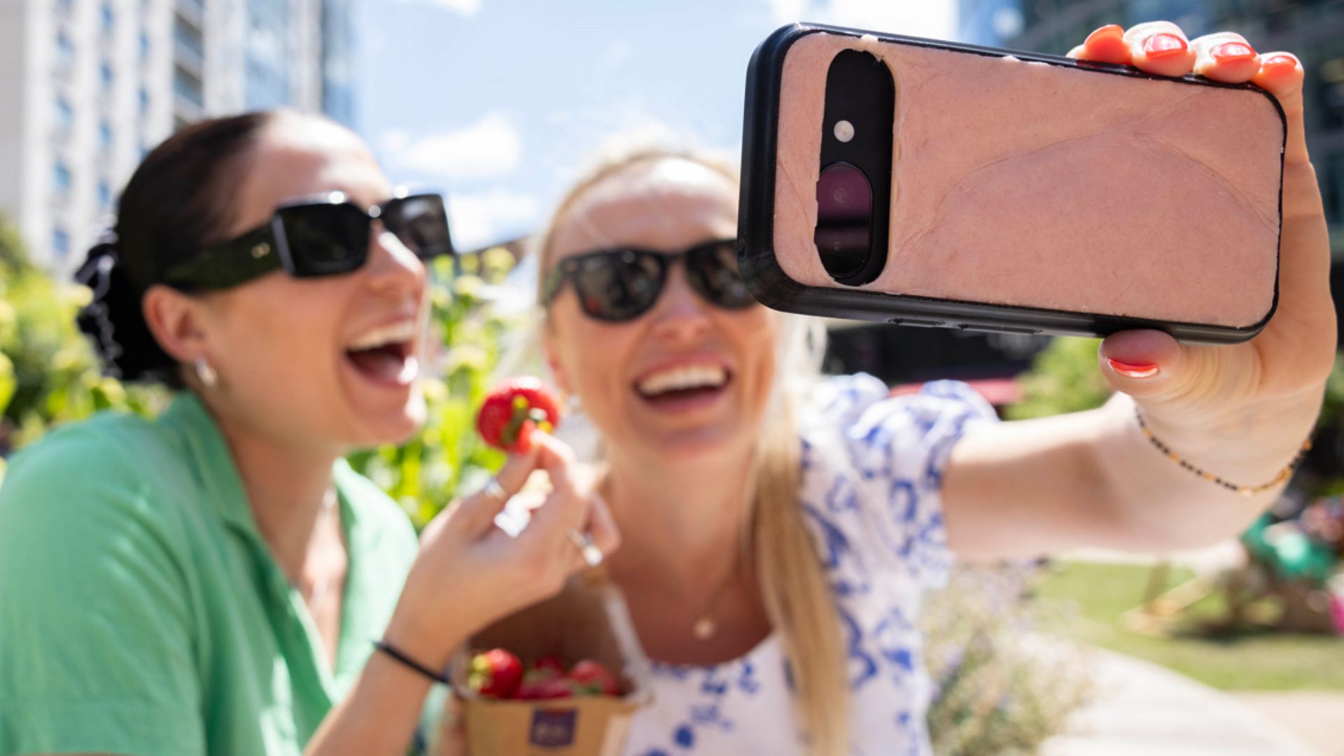 an image of two women taking a selfie, the phone is in focus and the case is the O2 skincase