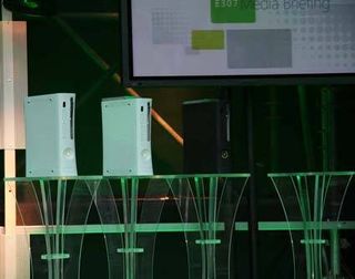 The three Xbox 360 consoles - core, premium and elite - with an empty pedestal for a fourth.
