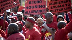 National Union of Metal workers South Africa (NUMSA) members sing and dance while protesting as they picket outside Eskom Megawatt Park in Sunnighill on the second day of their nationwide str