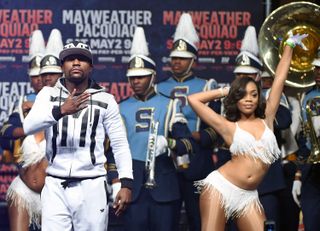 LAS VEGAS, NV - APRIL 28:WBC/WBA welterweight champion Floyd Mayweather Jr. (L) gestures as he arrives at MGM Grand Garden Arena on April 28, 2015 in Las Vegas, Nevada. Mayweather will face W