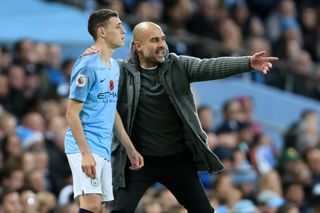 Manchester City manager Pep Guardiola gives instructions to a young Phil Foden in November 2018.