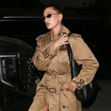 Hailey Bieber enjoyed a coffee-tasting session at Pacific Café in West Hollywood. She looked effortlessly stylish in a long tan trench coat with a classic belted waist, paired with navy loafers and retro sunglasses.