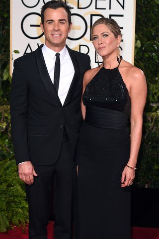 Jennifer Aniston wears Saint Laurent and Justin Theroux wears Givenchy at The Golden Globes 2015