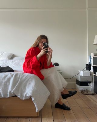 An image of influencer @brittanybathgate wearing a red shirt, one of the biggest shirt trends of 2025.