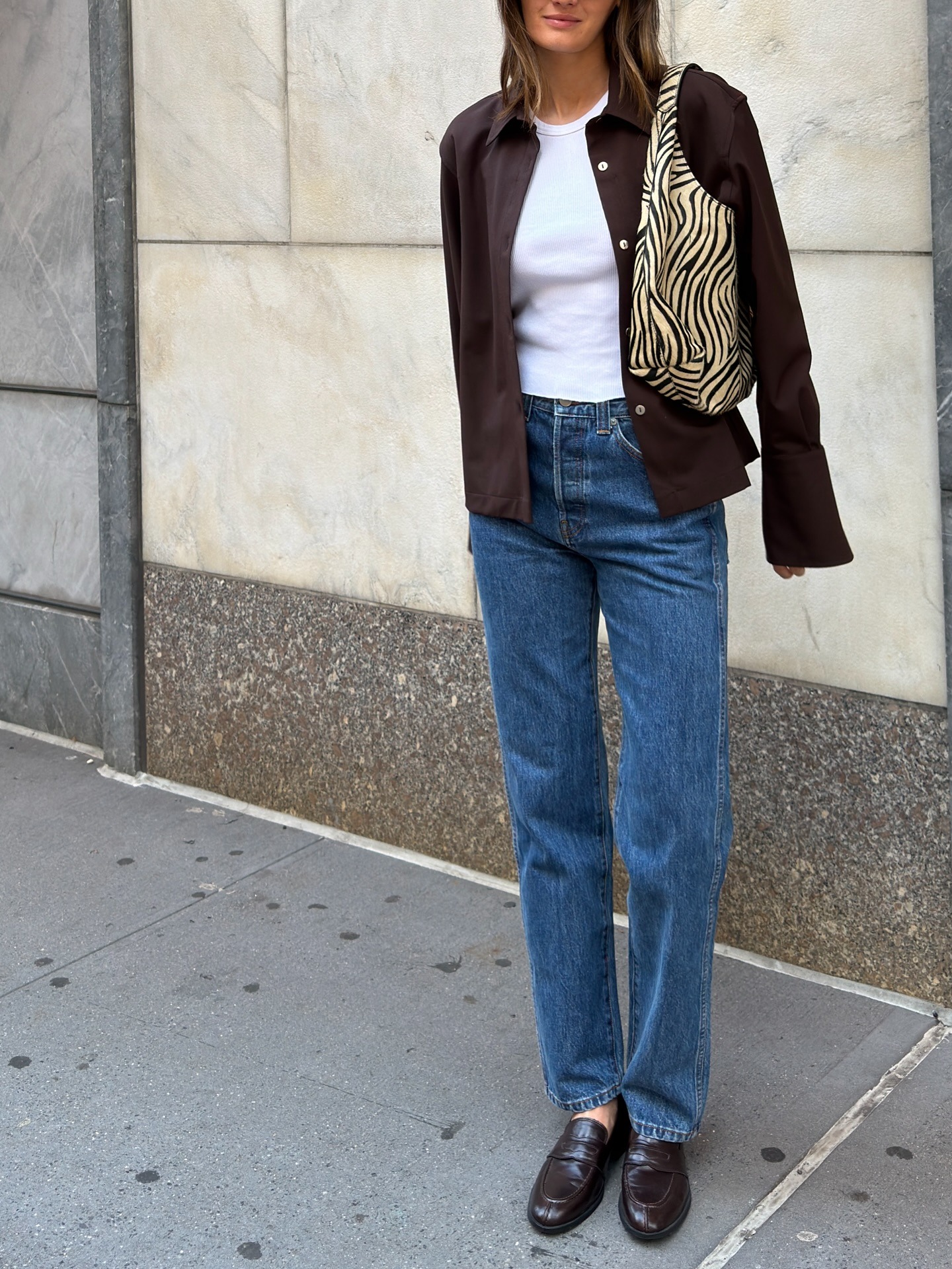 Person wearing jeans with loafers.