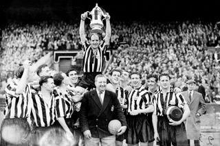 Newcastle United captain Jimmy Scoular is held up by his teammates with the FA Cup, as manager Doug Livingstone joins the celebrations following the victory over Manchester City in the 1955 FA Cup final at Wembley Stadium