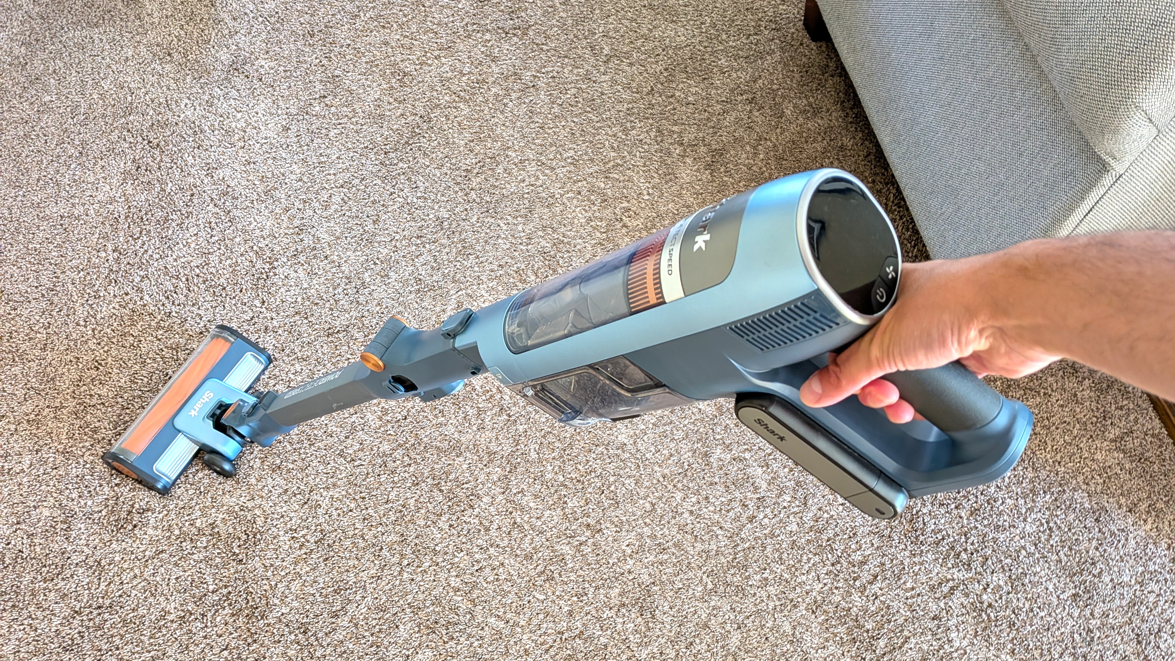 Person cleaning carpet with Shark PowerDetect Speed vacuum cleaner