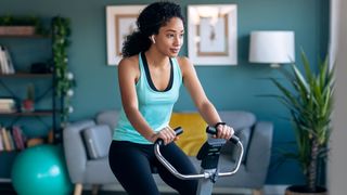Black Friday exercise bike deals: Woman working out on an exercise bike in her living room