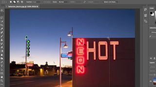 Photos of neon sign being edited in Photoshop