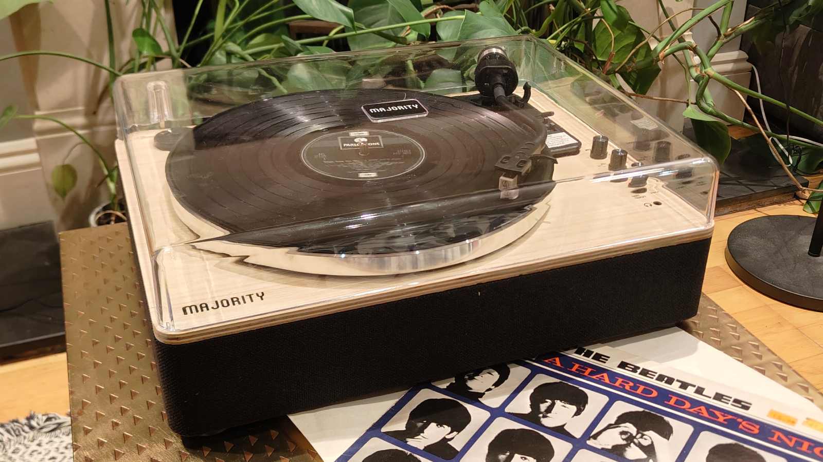 The Majority Folio on a bronze table with plants in the background.