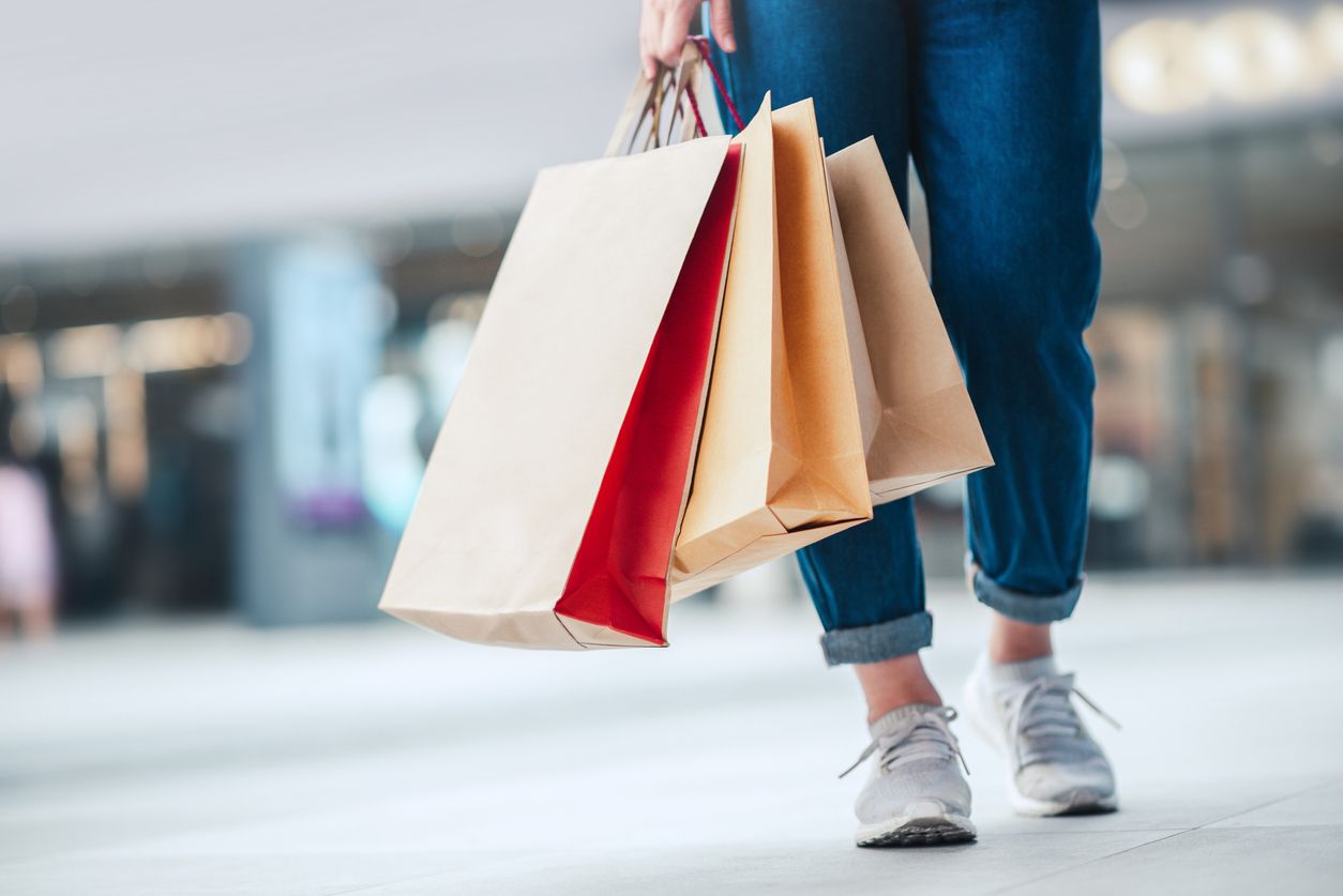 Person holding shopping bags.