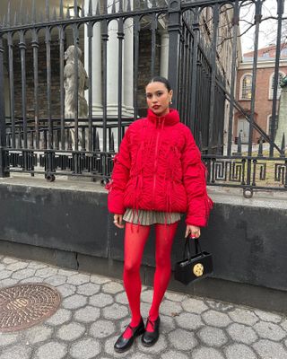 Woman wearing a red jacket and red tights