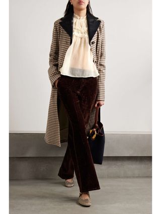 Net a Porter model wearing gauze blouse, corduroy pants, and checkered coat