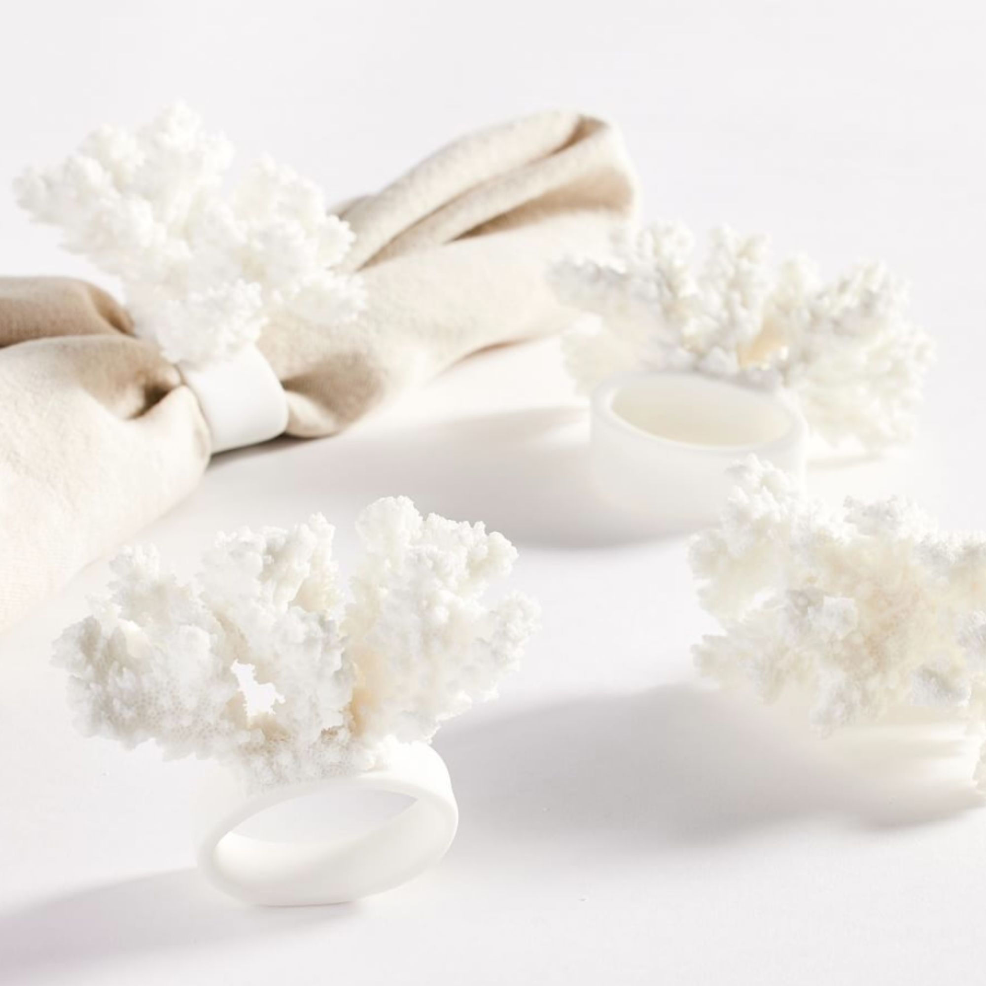 set of four white coral napkin rings