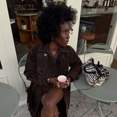 Woman wears brown suede trench coat, brown jumper