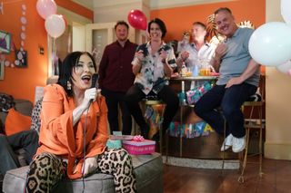 Kat Slater singing into a karaoke machine at the Slaters for Charli's birthday party