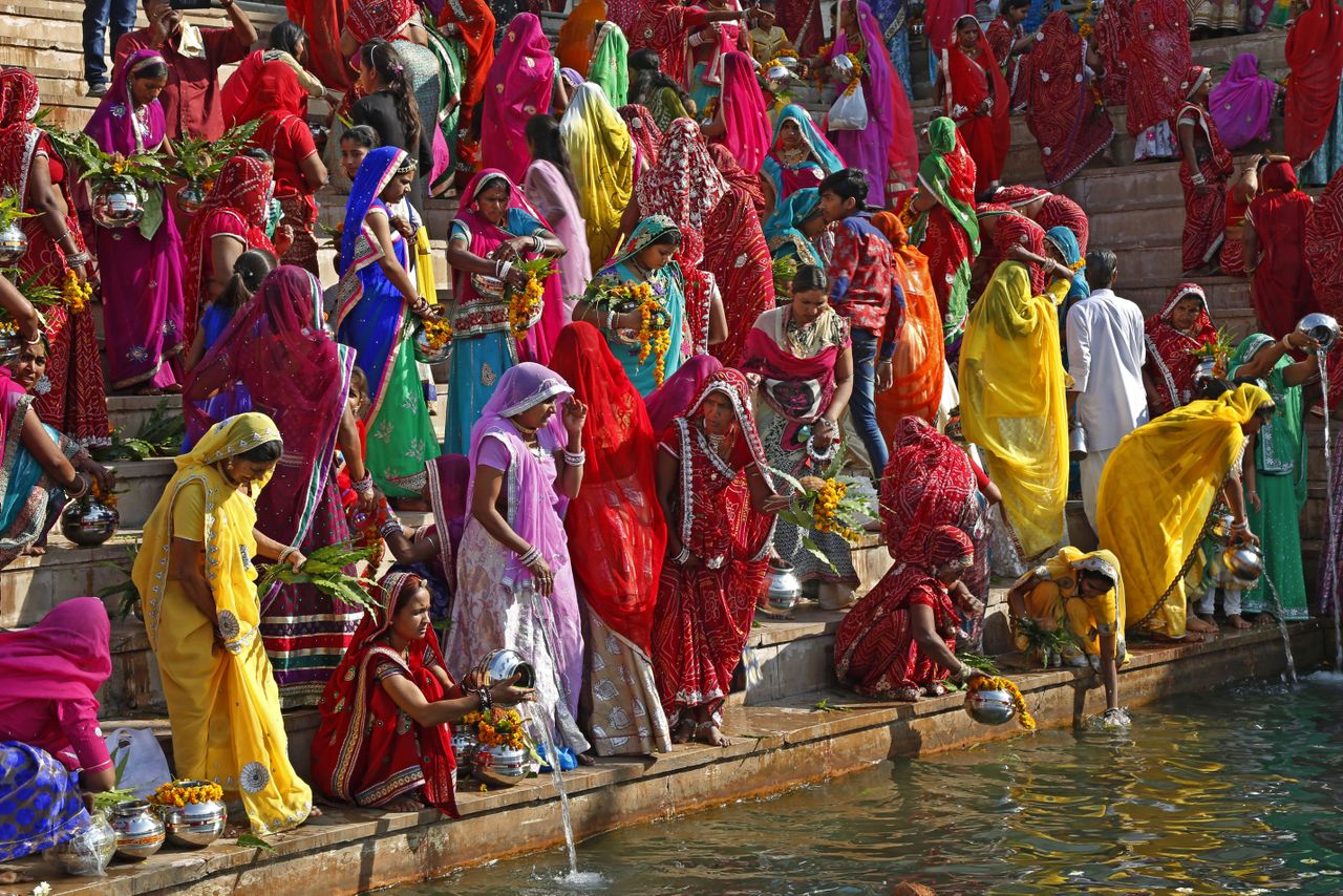 Hindu women collect water from the Pushkar lake to pour on idols of Lord Shiva, on occasion of Mahashivratri festival in Pushkar, India.