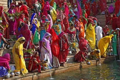 Hindu women collect water from the Pushkar lake to pour on idols of Lord Shiva, on occasion of Mahashivratri festival in Pushkar, India.