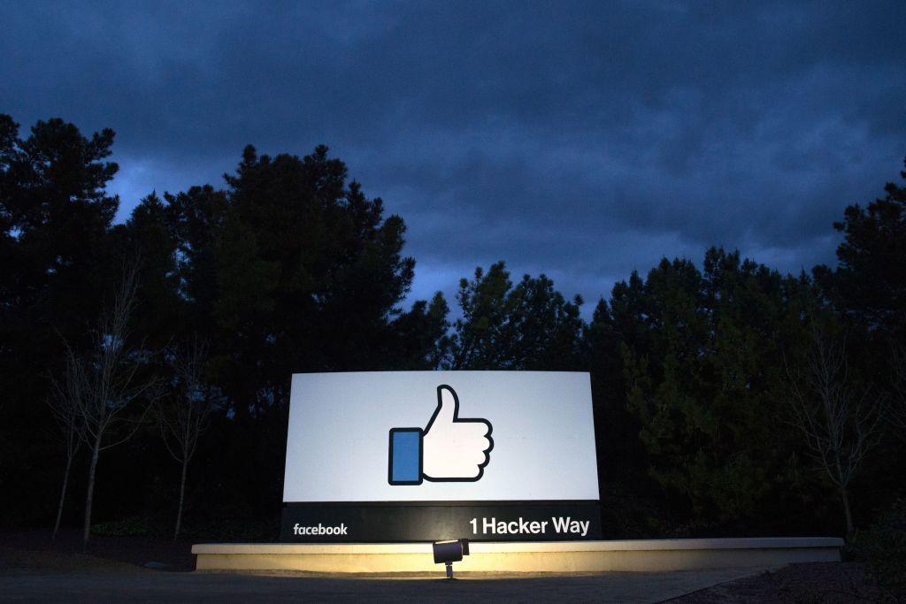 A lit sign is seen at the entrance to Facebook&amp;#039;s corporate headquarters location in Menlo Park, California on March 21, 2018