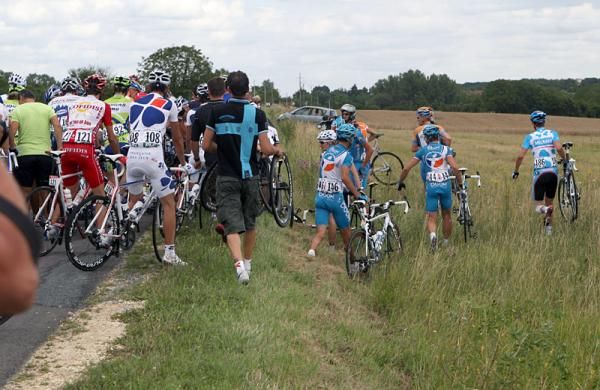 Several riders decided to walk through a field to bypass a crash.