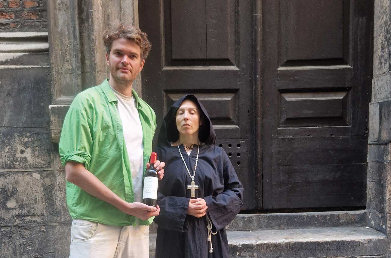 Matthew Green with bottle of wine on medieval wine tour