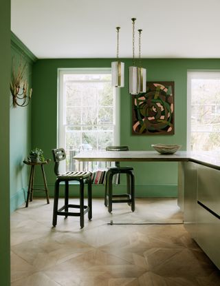 green kitchen with green walls and artwork