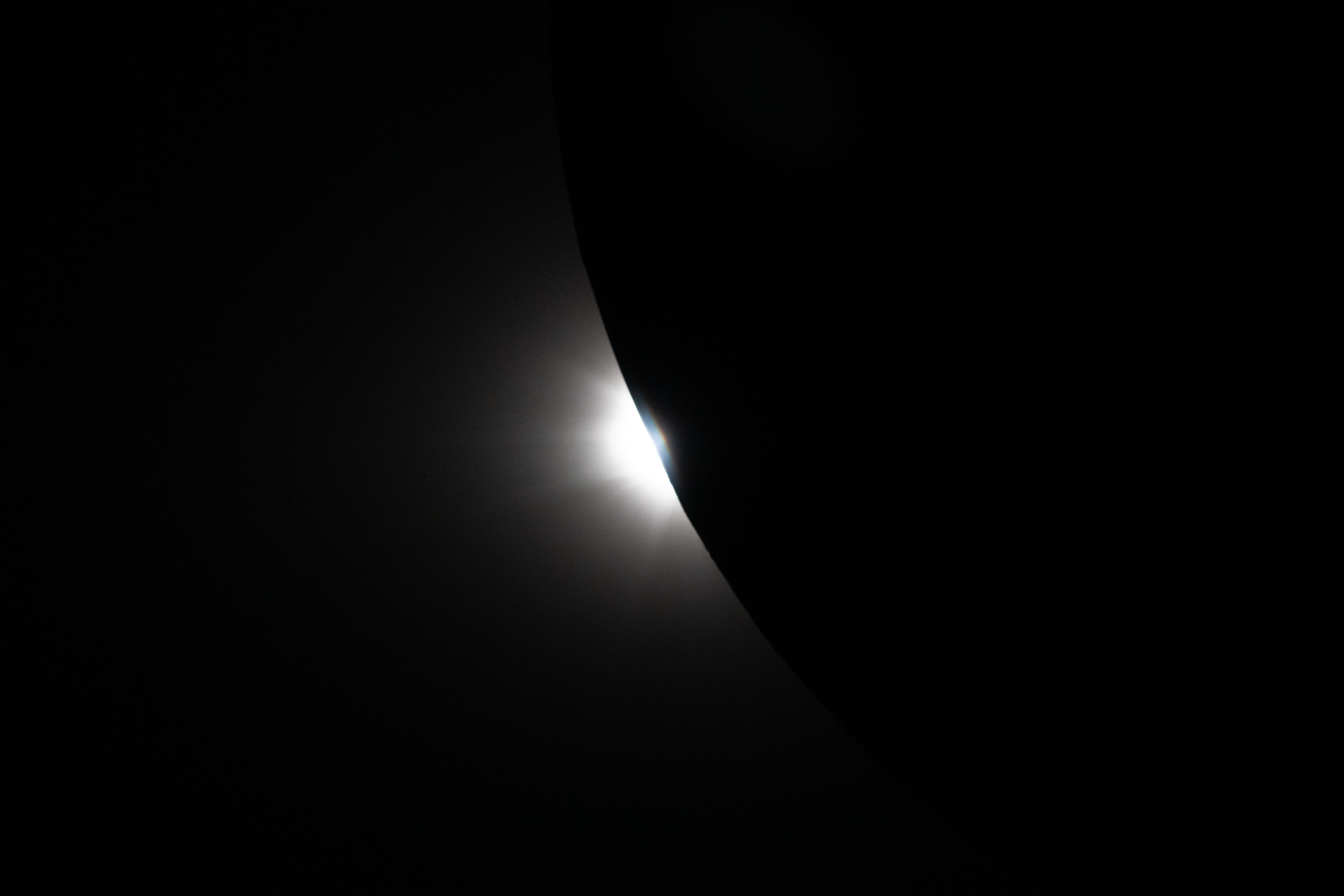 Pictures from Artemis II during the solar eclipse that the astronauts experienced from the dark side of the moon. This image shows the sun beginning to peak around the Moon