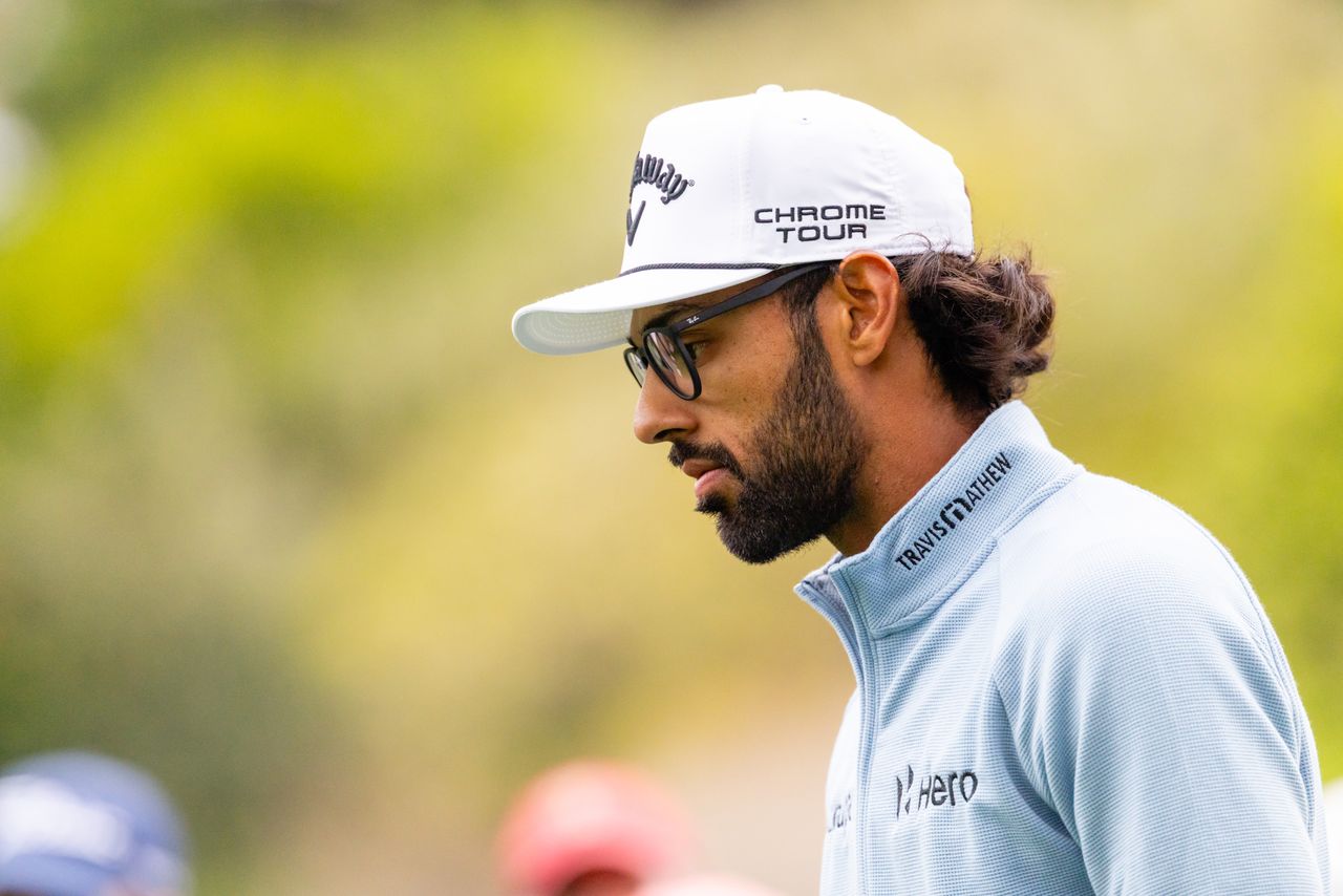 Akshay Bhatia looks on as he walks off the green
