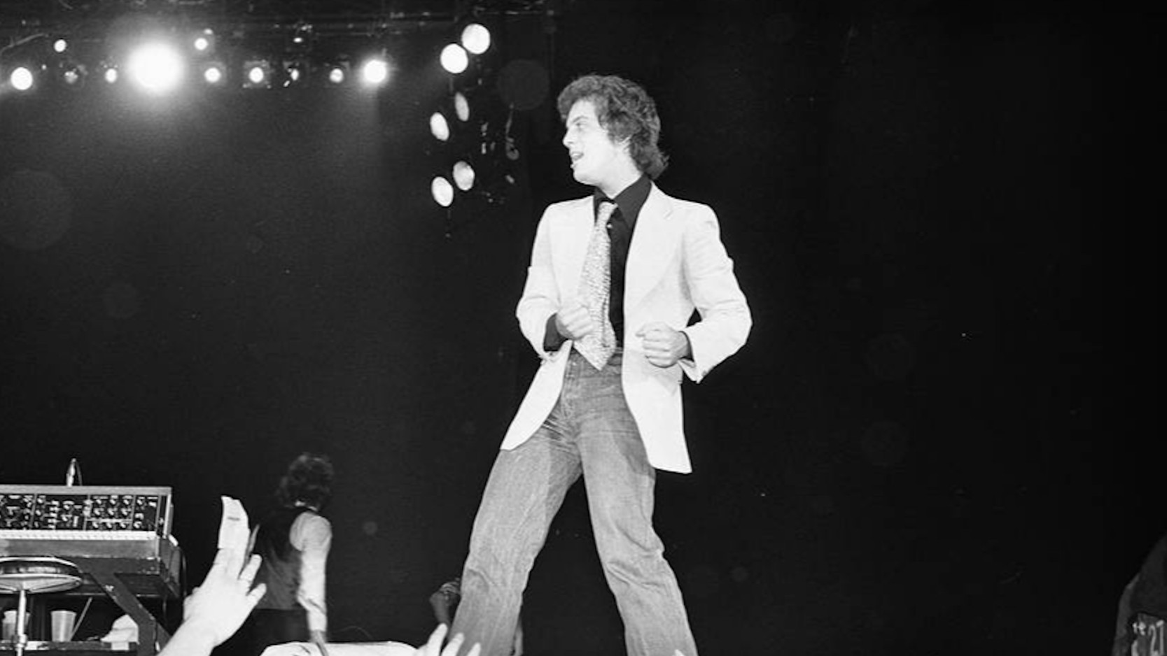 Black and white photo of Billy Joel on stage