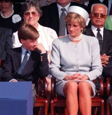 Prince Charles, Prince William, Princess Diana and Prince Harry sitting in a row in chairs
