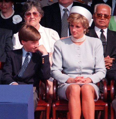 Prince Charles, Prince William, Princess Diana and Prince Harry sitting in a row in chairs