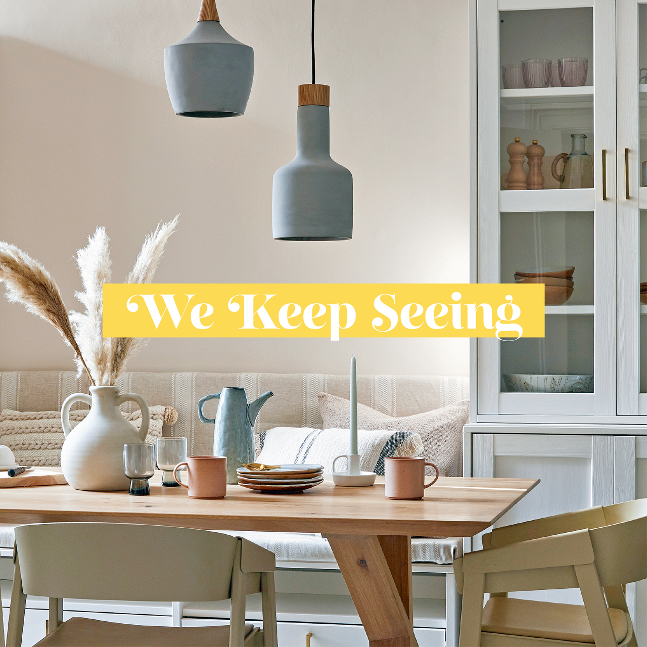 Neutral dining room with pale powder blue ceramic pendant lights hung over a wooden dining table
