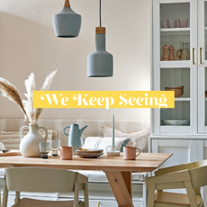 Neutral dining room with pale powder blue ceramic pendant lights hung over a wooden dining table