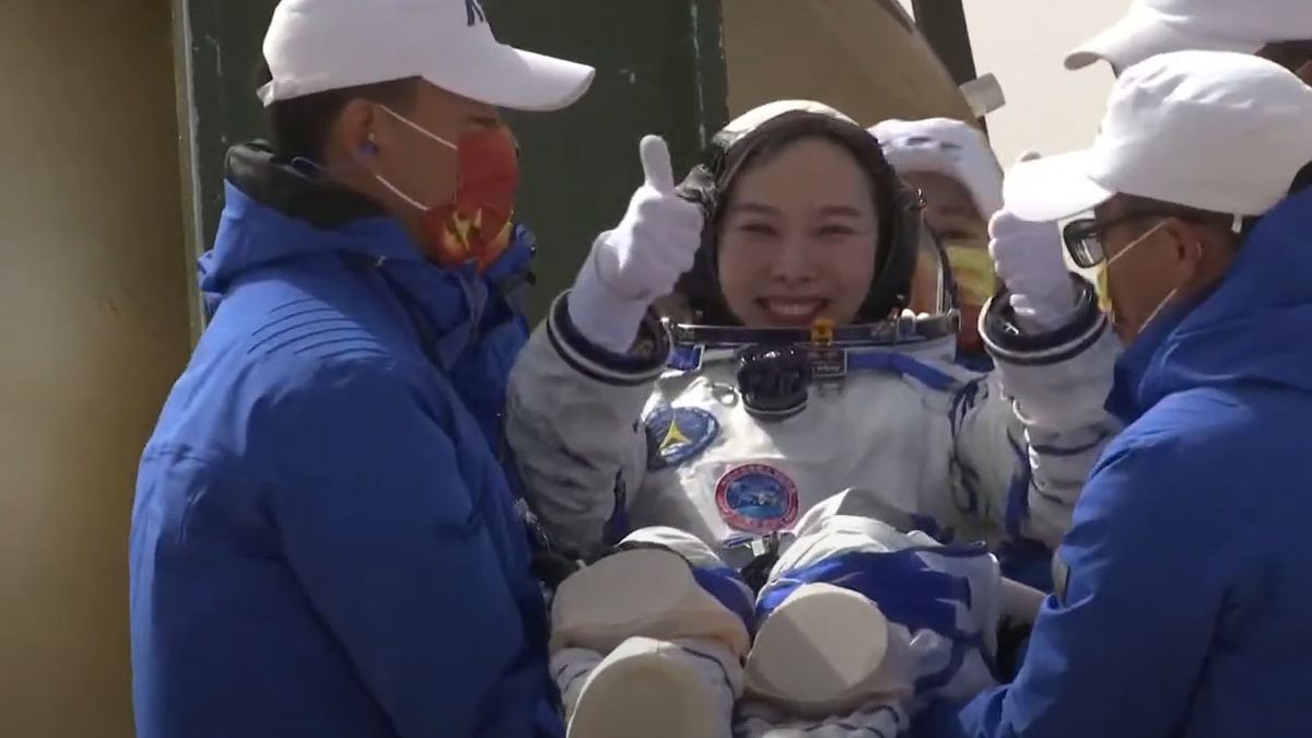 Chinese astronaut Wang Yaping of the Shenzhou 13 mission gives two thumb's up after landing in the Gobi Desert to end a six-month mission to the Tiangong space station on April 16, 2022.