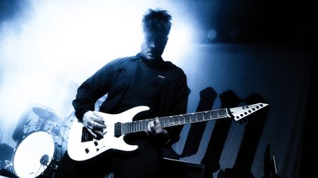 Black and white image of Varials guitarist Shane Lyons playing onstage