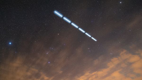 A dashed line of light in the night sky