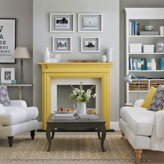 Grey room with yellow fireplace and white sofas