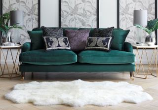 Dunelm Rupert sofa in a white and grey living room, with a plush white rug, wooden floor, marble side tables and grey vintage artwork on the walls