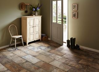 Slate blend brown floor tiles in country inspired entryway with wooden vintage furniture