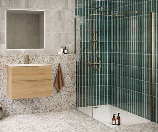 shower enclosure with wall mounted shower, frameless glass screen and green tiles