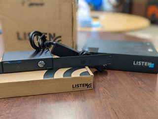 The LISTEN Everywhere device sitting atop its box.