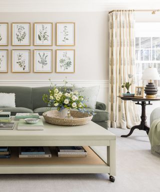 Neutral living room with sage green sofa and floral print gallery wall