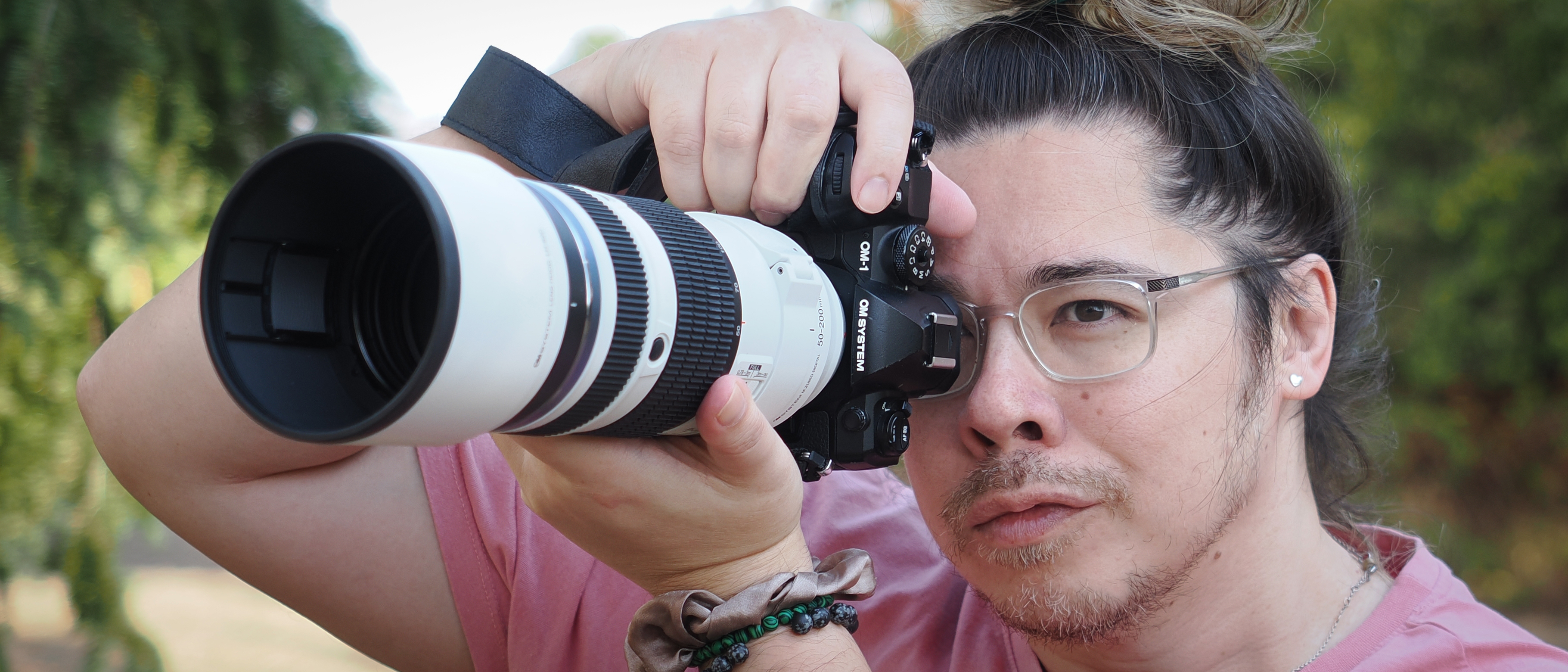 The OM System M.Zuiko 50-200mm f/2.8 IS Pro lens, mounted to the OM System OM-1 Mark II, being used by photographer James Artaius