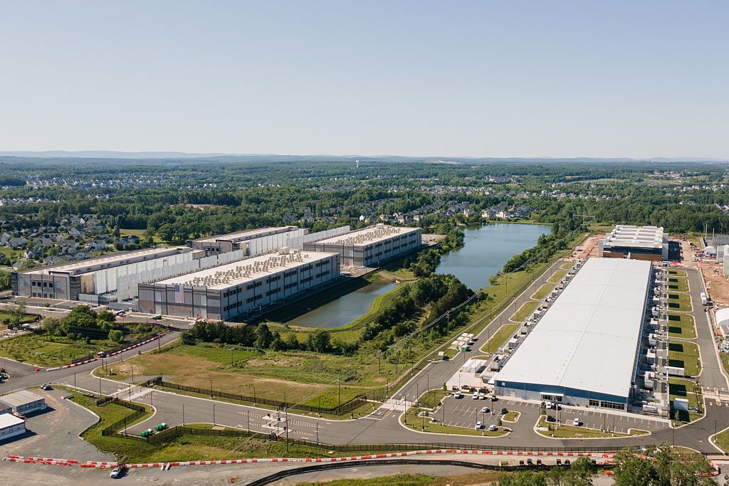 Aerial view of a huge Microsoft Azure data center in Aldie, Virginia. There is a lake next to the data center.