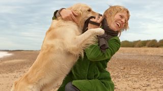 Dog jumping up at a woman