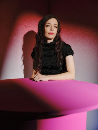 BAFTA Breakthrough 2023; a woman in black on a blue and red background