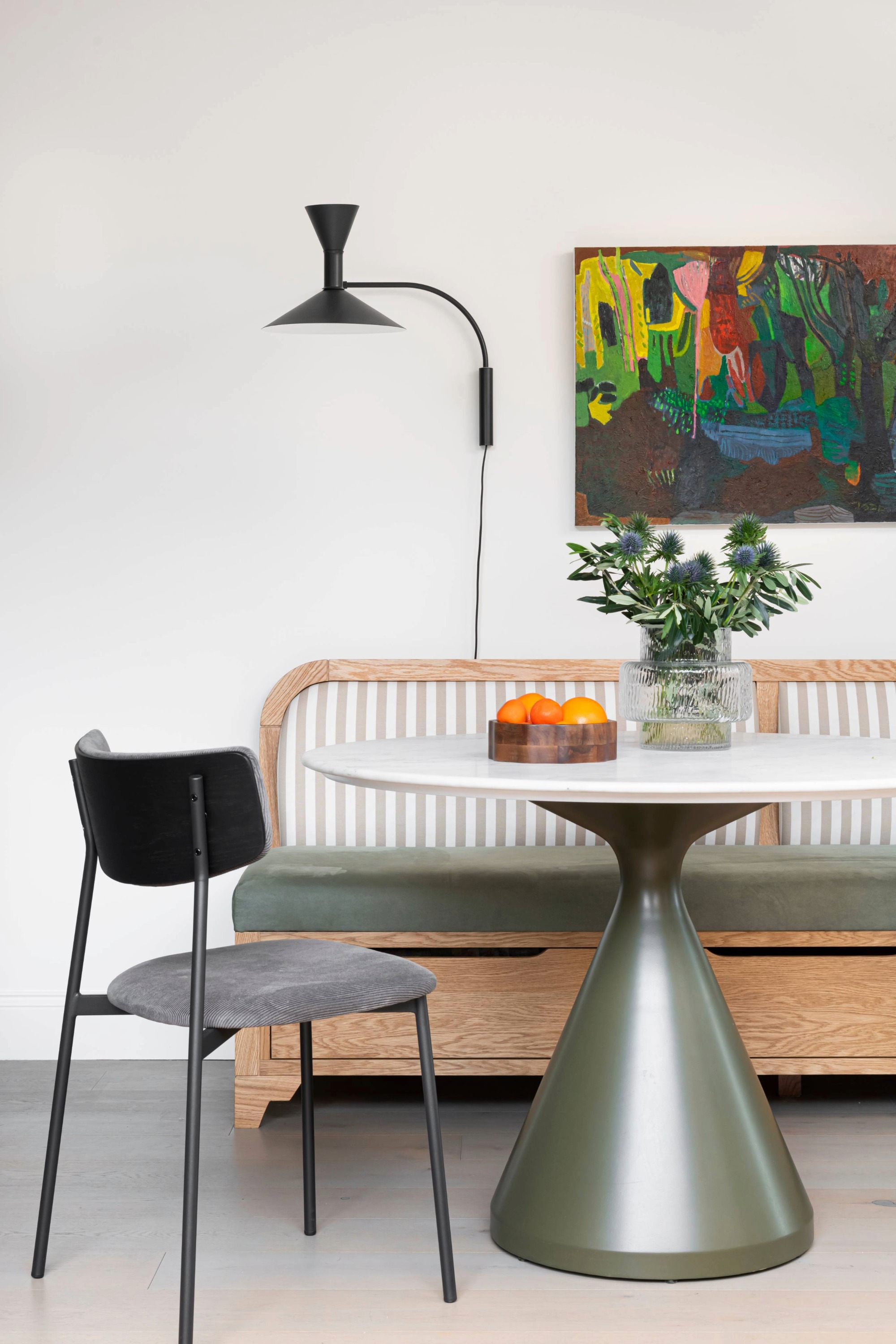 dining area with banquette seating and round pedestal dining table