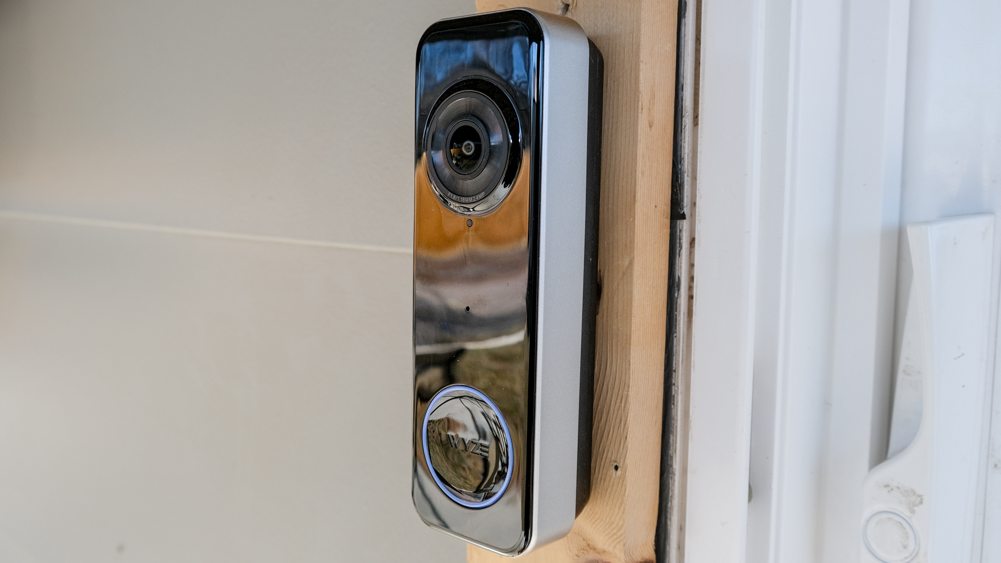A Wyze Battery Video Doorbell mounted on a door frame