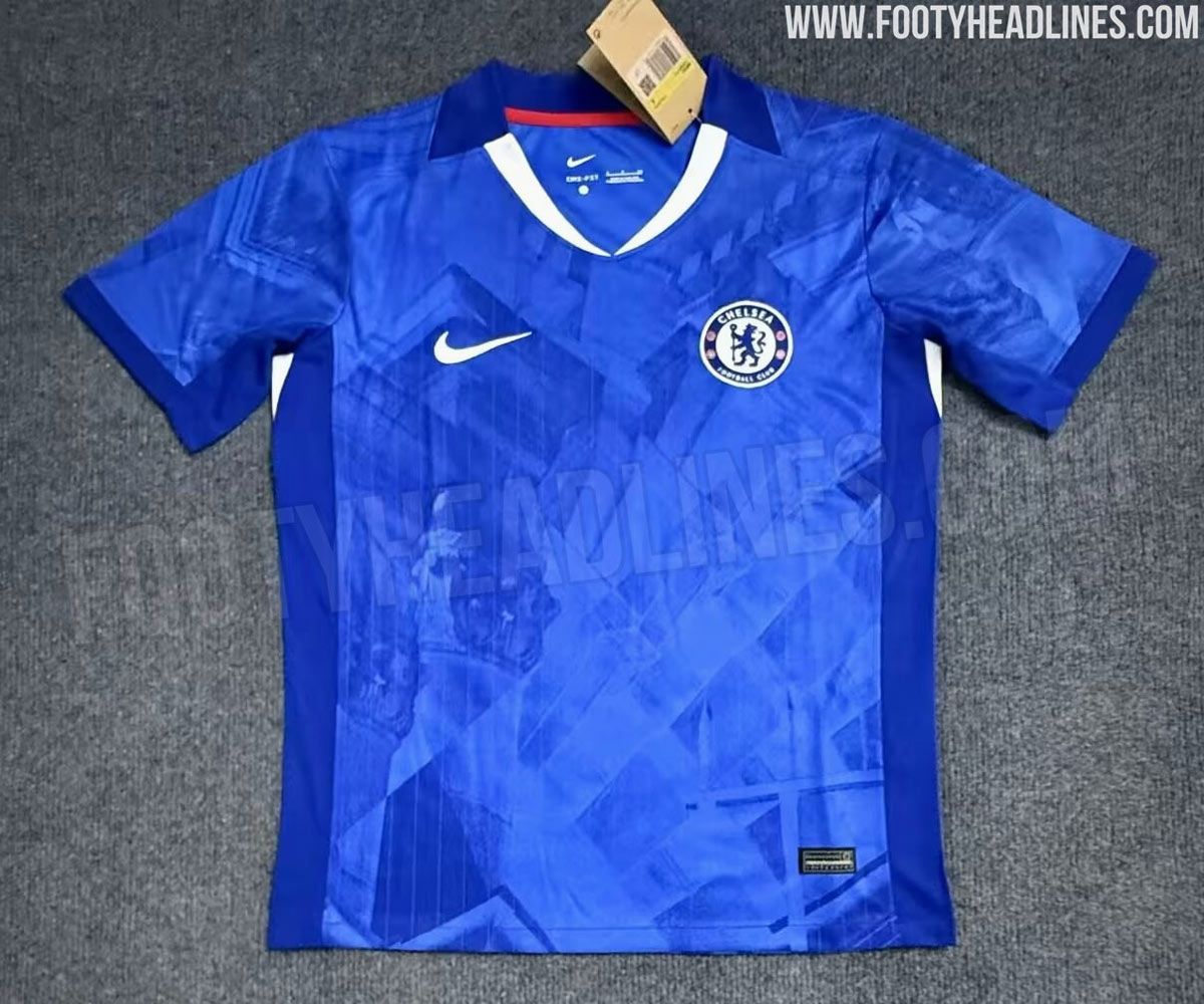 A sharply patterned blue top with a white tick on the left breast and a small circular logo with a blue lion on the right, a red and white stripe down the sides and a sharp pattern covering the back